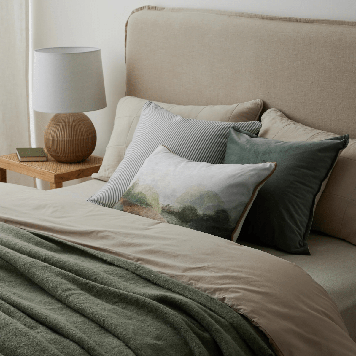 Cushions and a throw on a made bed, Madras Link