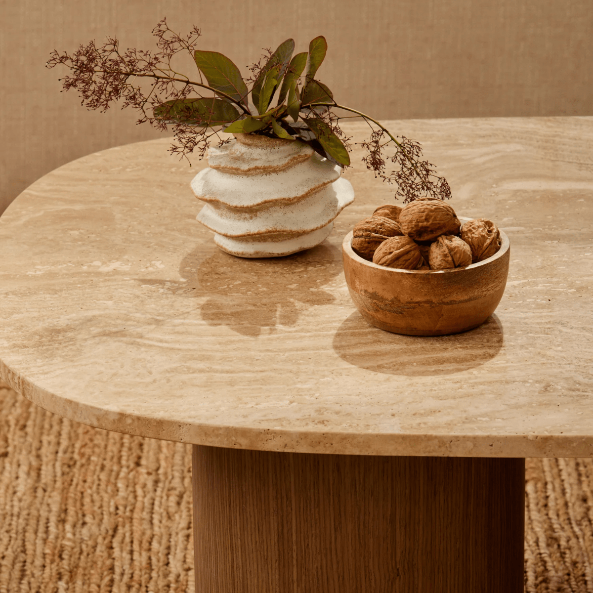 A bud vase with dried stems on a travertine table, Madras Link
